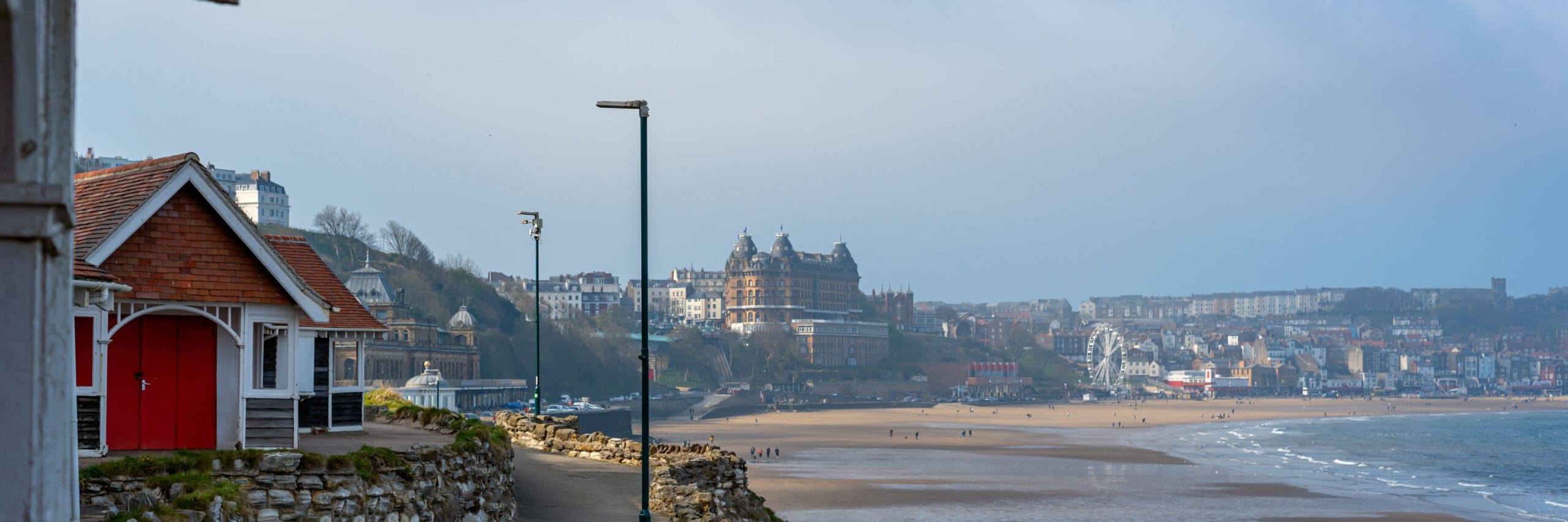 Colourful old beach huts or summer houses on South Bay Beach at Scarborough, Yorkshire, UK. Houses are old, paint cracks, banner size